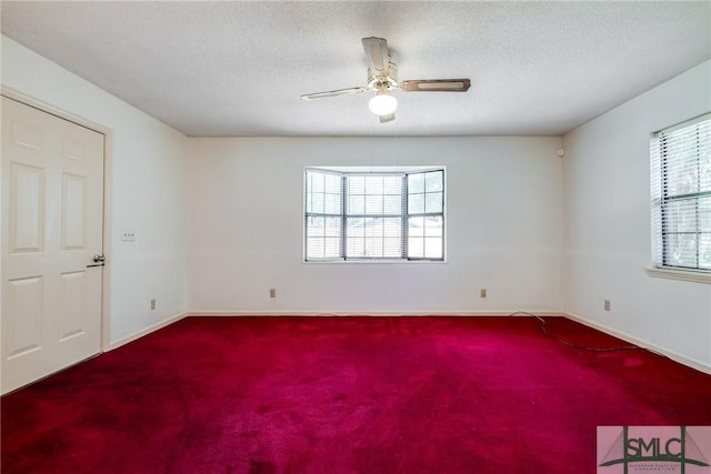 empty room featuring baseboards, carpet flooring, and a ceiling fan