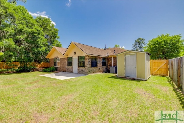 rear view of house featuring a patio, a fenced backyard, a storage unit, central AC unit, and a lawn
