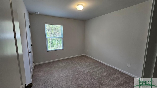 empty room featuring carpet floors and baseboards