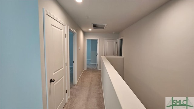 corridor featuring visible vents, light carpet, baseboards, recessed lighting, and an upstairs landing