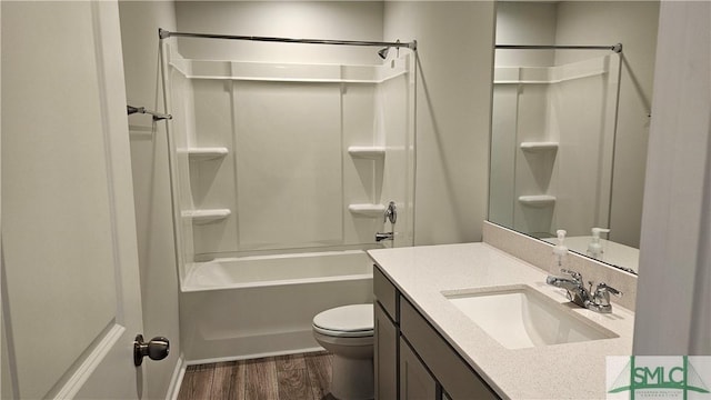 bathroom featuring shower / bath combination, vanity, toilet, and wood finished floors