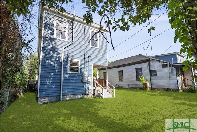 back of property featuring a yard