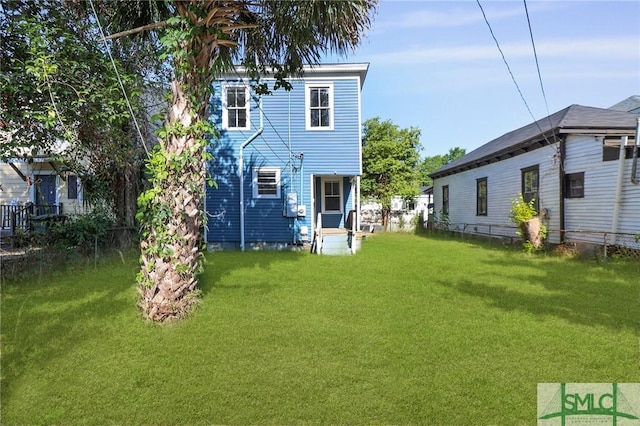 back of house featuring a yard