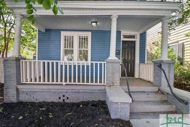 view of exterior entry featuring a porch