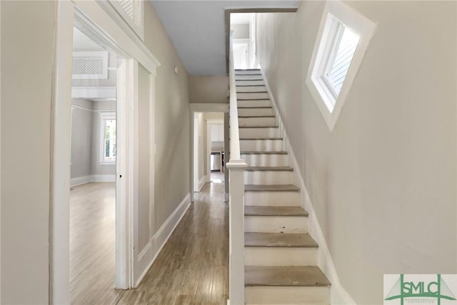 stairway featuring baseboards and wood finished floors