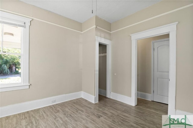 unfurnished bedroom featuring baseboards and wood finished floors