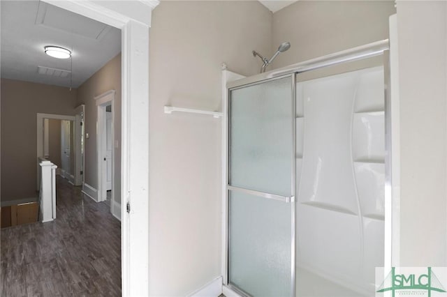 bathroom with visible vents, wood finished floors, and a stall shower