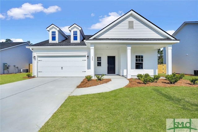 view of front of home featuring a garage, cooling unit, a front yard, and concrete driveway