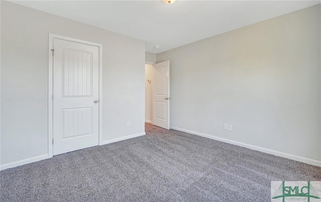unfurnished bedroom featuring carpet floors and baseboards