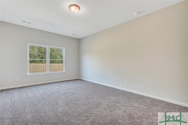 carpeted empty room with baseboards and visible vents