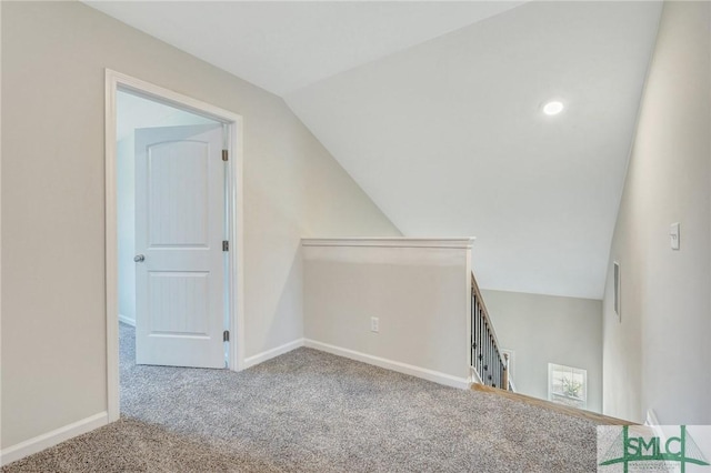 additional living space with carpet flooring, baseboards, and lofted ceiling