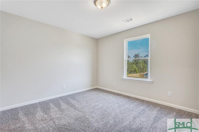 carpeted empty room featuring baseboards and visible vents