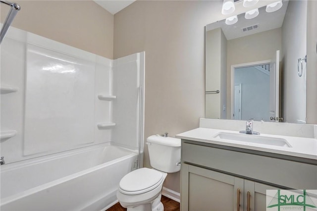bathroom featuring vanity, toilet, baseboards, bathing tub / shower combination, and wood finished floors