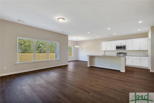 kitchen featuring visible vents, dark wood-type flooring, appliances with stainless steel finishes, and a chandelier