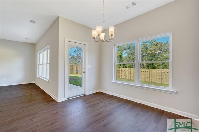 interior space with baseboards, an inviting chandelier, visible vents, and dark wood-type flooring