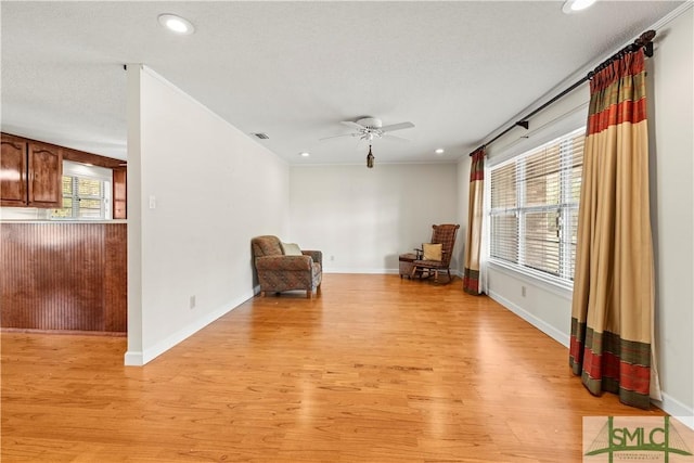 living area with a ceiling fan, baseboards, recessed lighting, and light wood finished floors