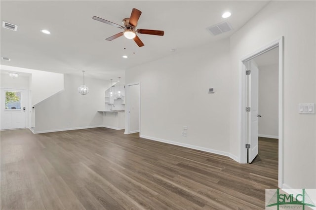 127 Lower Creek Dr, Richmond Hill, GA 31324 - unfurnished living room with visible vents, baseboards, ceiling fan, and wood finished floors
