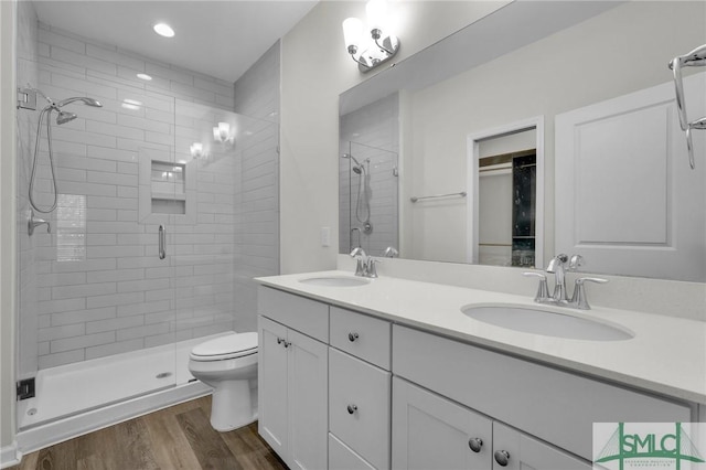 127 Lower Creek Dr, Richmond Hill, GA 31324 - full bathroom featuring a sink, a shower stall, and wood finished floors
