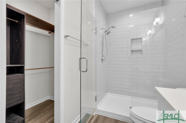 127 Lower Creek Dr, Richmond Hill, GA 31324 - bathroom with vanity, wood finished floors, toilet, and a shower stall