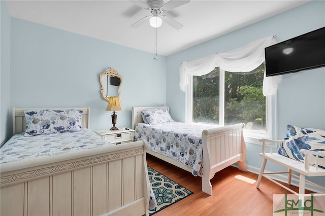 106 Pelican Ct, Tybee Island, GA 31328 - bedroom with baseboards, a ceiling fan, and light wood-style flooring