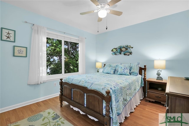 106 Pelican Ct, Tybee Island, GA 31328 - bedroom featuring baseboards, a ceiling fan, and light wood-style flooring