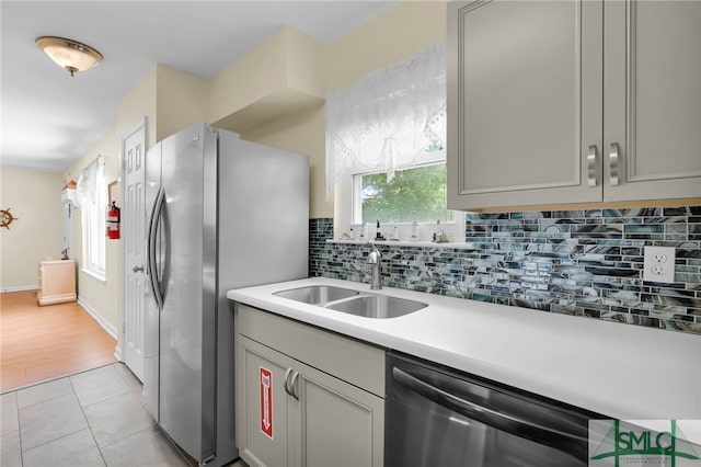 106 Pelican Ct, Tybee Island, GA 31328 - kitchen featuring a sink, appliances with stainless steel finishes, plenty of natural light, and backsplash