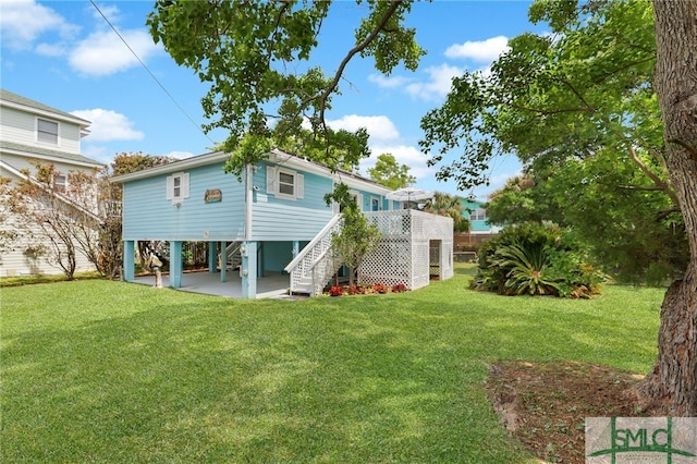 106 Pelican Ct, Tybee Island, GA 31328 - rear view of house featuring stairs and a yard
