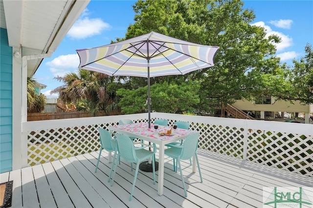 106 Pelican Ct, Tybee Island, GA 31328 - wooden terrace featuring outdoor dining space