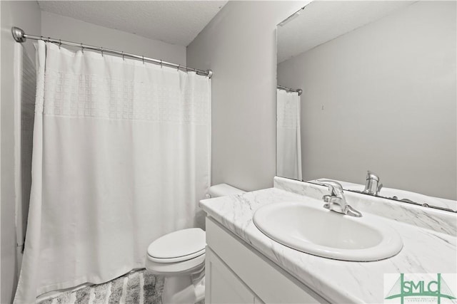 63 Springer Cir, Ludowici, GA 31316 - full bathroom with vanity, toilet, and a textured ceiling
