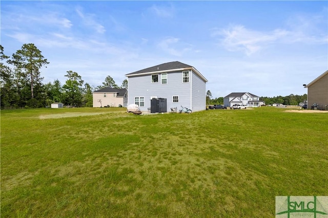 63 Springer Cir, Ludowici, GA 31316 - rear view of property featuring a lawn and cooling unit