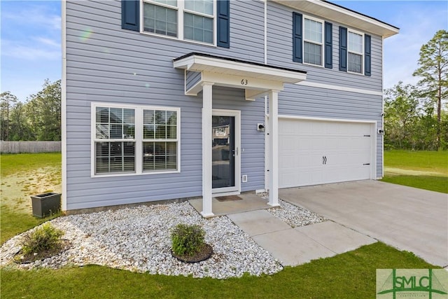 63 Springer Cir, Ludowici, GA 31316 - traditional home featuring an attached garage and concrete driveway