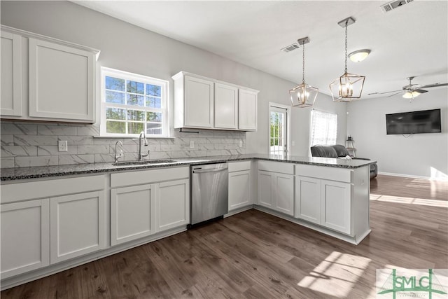 63 Springer Cir, Ludowici, GA 31316 - kitchen featuring backsplash, stainless steel dishwasher, a sink, white cabinets, and a peninsula