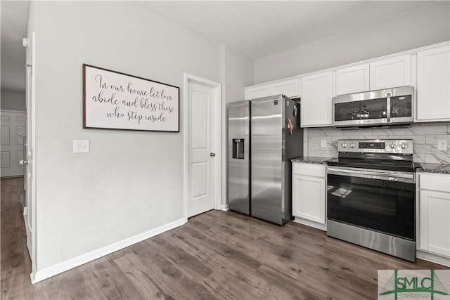 63 Springer Cir, Ludowici, GA 31316 - kitchen featuring appliances with stainless steel finishes, dark wood-style floors, and white cabinetry