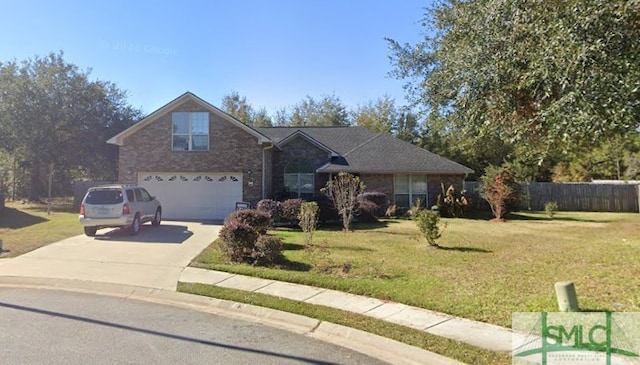 traditional-style home featuring fence, an attached garage, driveway, and a front lawn