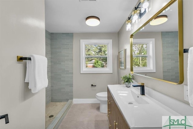 1107 E Derenne Ave, Savannah, GA 31406 - bathroom with vanity, a wealth of natural light, toilet, and tiled shower