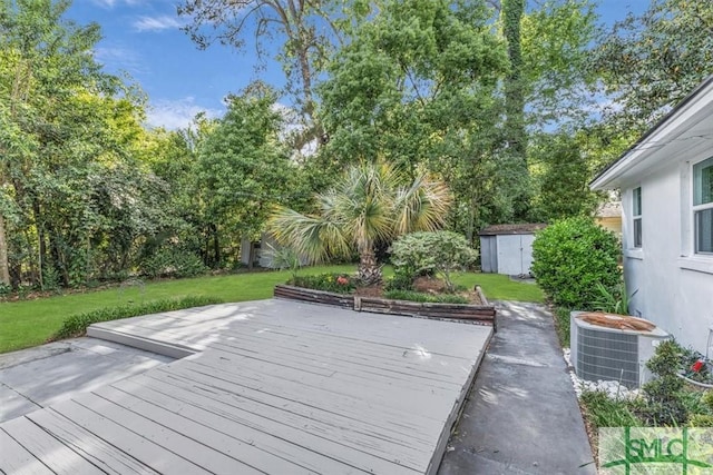 1107 E Derenne Ave, Savannah, GA 31406 - wooden terrace featuring central air condition unit, an outdoor structure, a lawn, and a shed