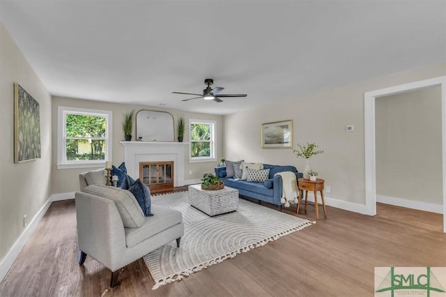 1107 E Derenne Ave, Savannah, GA 31406 - living room with baseboards, ceiling fan, a healthy amount of sunlight, and wood finished floors