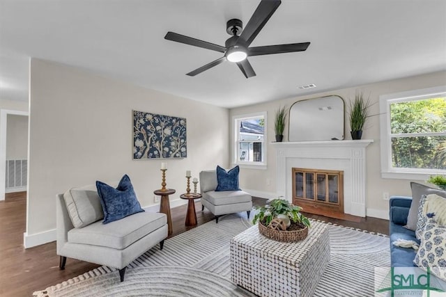 1107 E Derenne Ave, Savannah, GA 31406 - living area featuring plenty of natural light, a fireplace with flush hearth, baseboards, and a ceiling fan