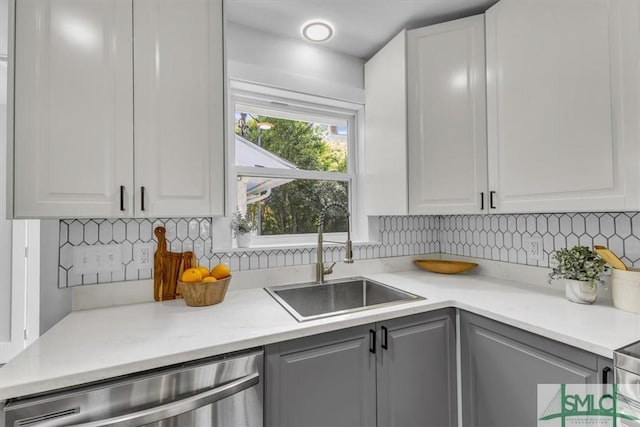 1107 E Derenne Ave, Savannah, GA 31406 - kitchen featuring a sink, dishwasher, light countertops, white cabinetry, and decorative backsplash