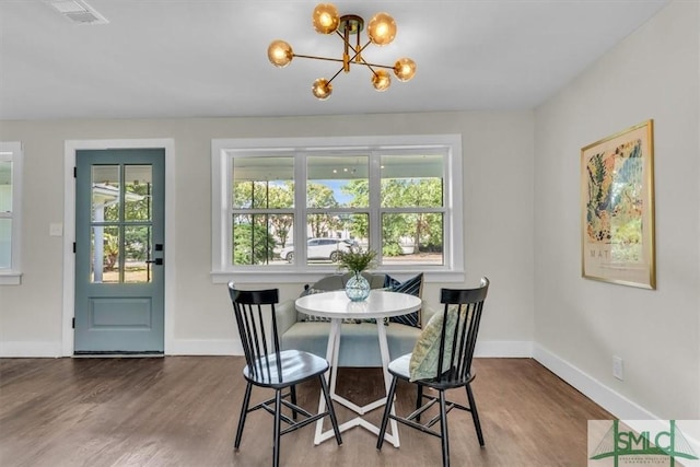 1107 E Derenne Ave, Savannah, GA 31406 - dining room with baseboards, a chandelier, wood finished floors, and visible vents