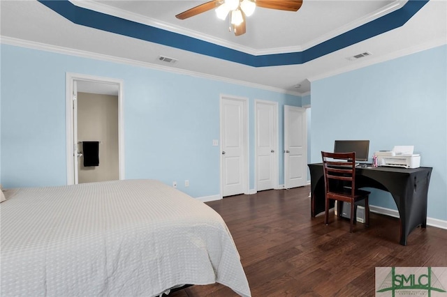 bedroom featuring baseboards, ornamental molding, wood finished floors, and visible vents