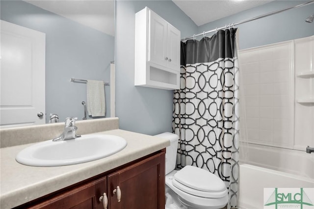 bathroom with vanity, shower / tub combo with curtain, and toilet