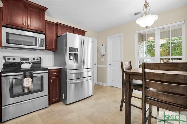 kitchen featuring visible vents, decorative backsplash, dark brown cabinets, light countertops, and appliances with stainless steel finishes