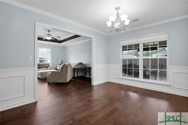 dining room featuring crown molding, wainscoting, wood finished floors, and visible vents