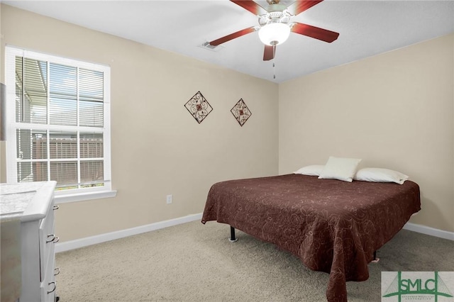 carpeted bedroom featuring baseboards, visible vents, multiple windows, and ceiling fan