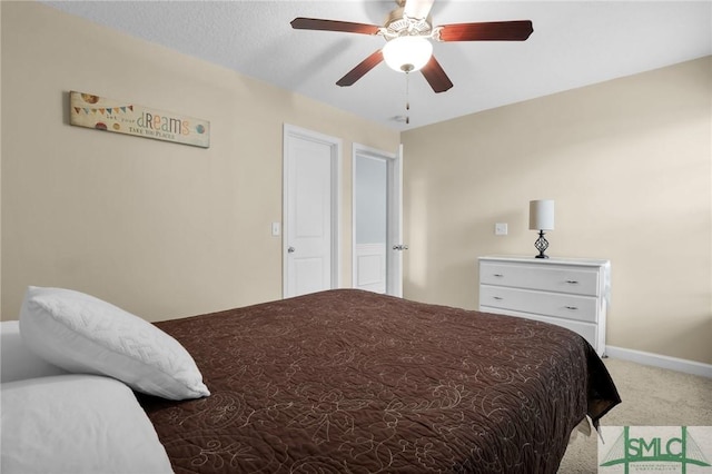 bedroom with a ceiling fan, baseboards, and light colored carpet