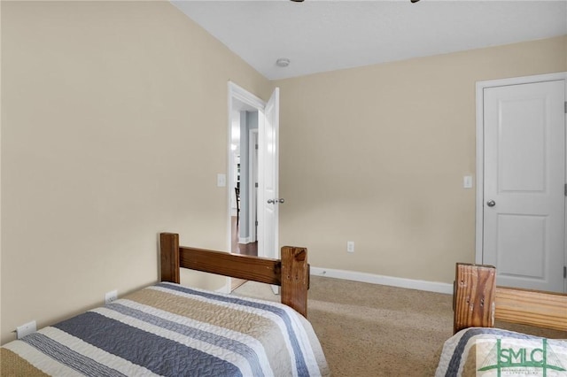 bedroom with baseboards and carpet