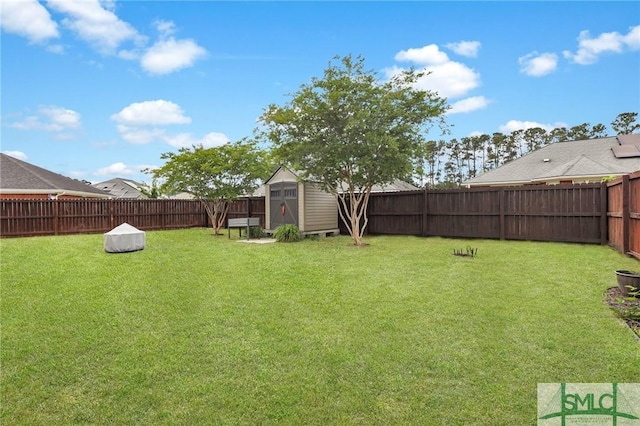 view of yard with an outbuilding, a fenced backyard, and a shed