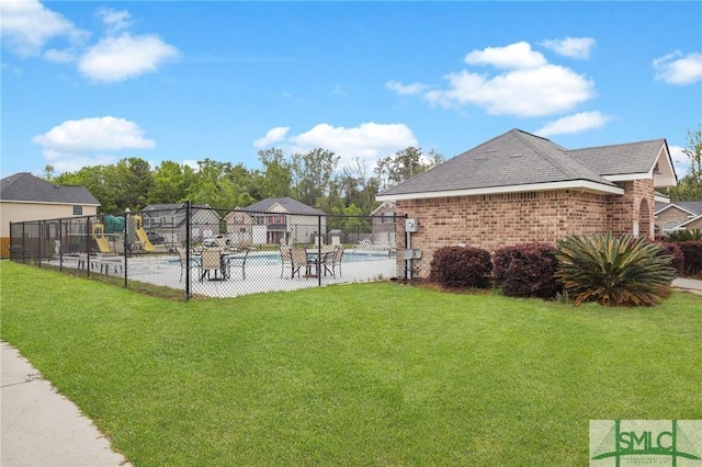 view of yard with fence and playground community