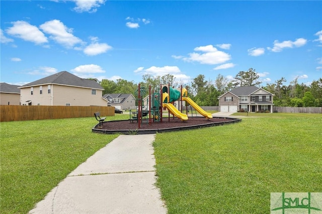 view of jungle gym with fence and a lawn